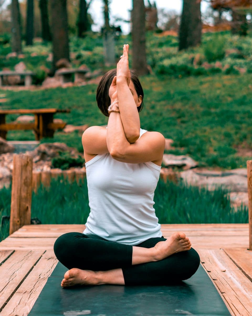 Woman meditating in a garden