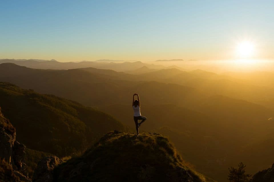 Yoga at sunrise high in the mountains